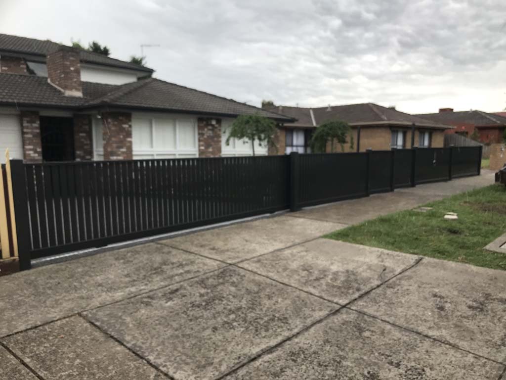 Capped picket fence with an auto sliding gate