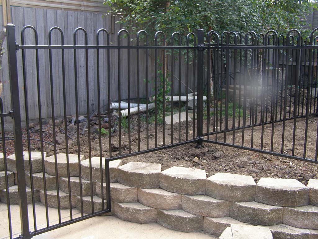 Pool fencing built over retaining walls